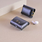 Case for AirPods in black leather with messing clip, with earbuds. Cases for AirPods Pro 2, AirPods Pro 3 and AirPods 4. Personalisation with monogram.